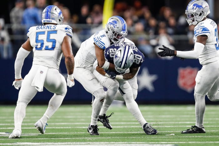 Detroit Lions safety Ifeatu Melifonwu (6) tackles Dallas Cowboys running back Tony Pollard (20) during the second half at AT&T Stadium in Arlington, Texas on Saturday, Dec. 30, 2023.